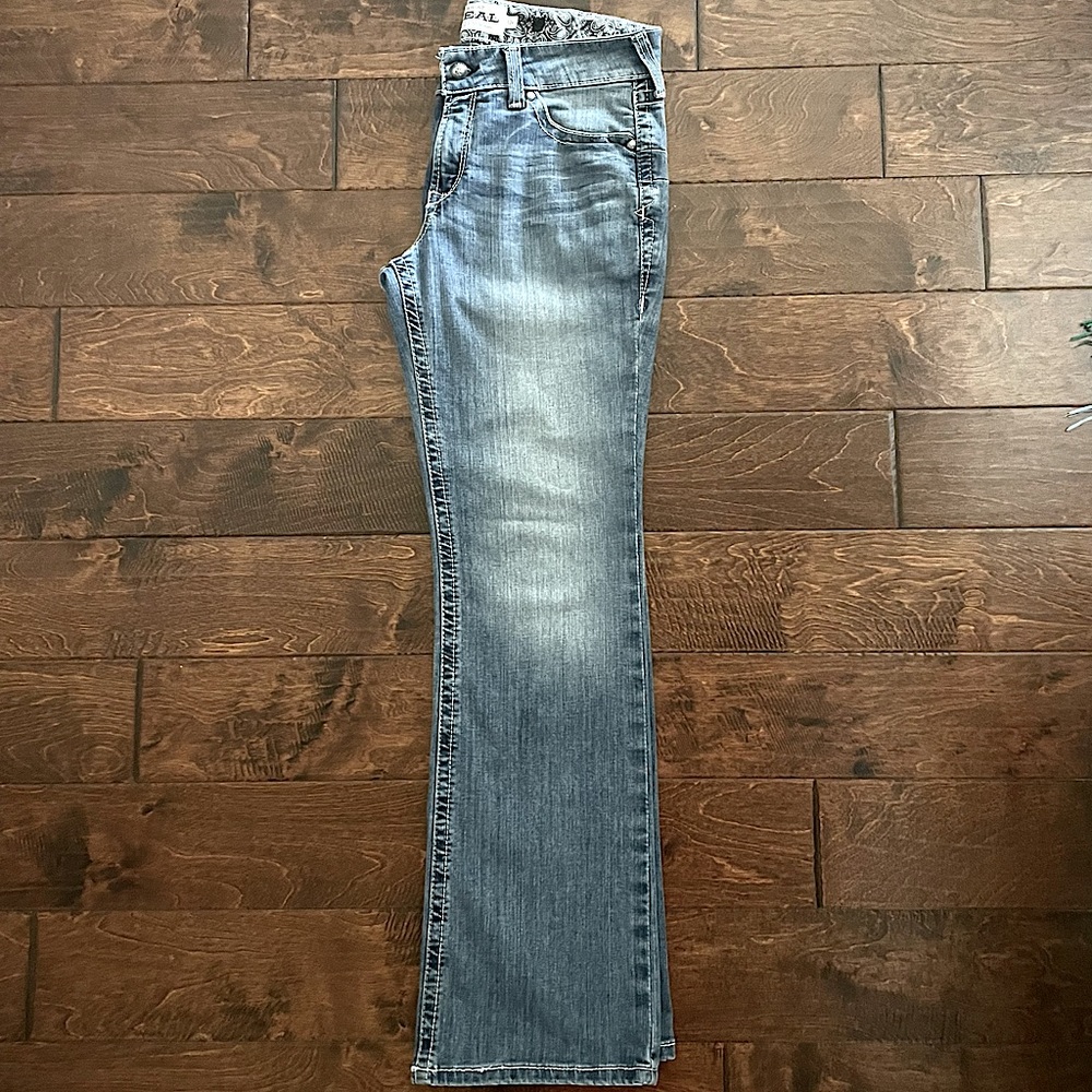 R.E.A.L. Mid Rise Stretch Whipstitch Boot Cut Jean